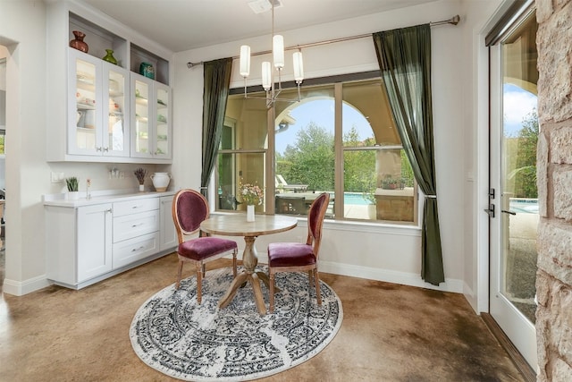 dining room featuring baseboards and an inviting chandelier