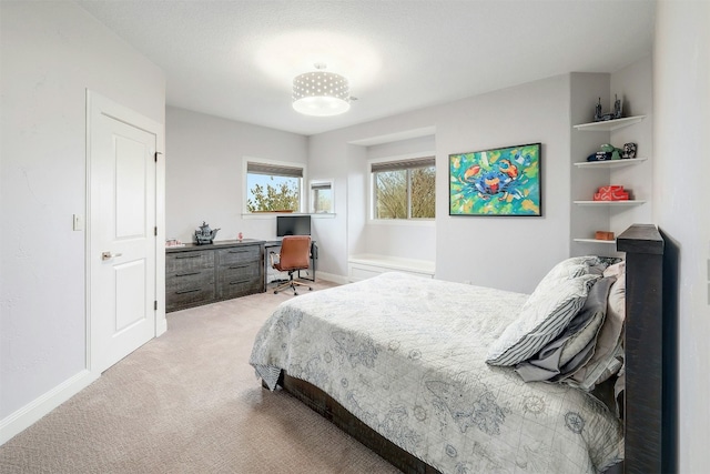 bedroom featuring light carpet and baseboards