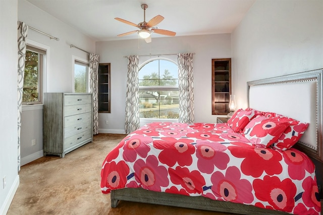 bedroom featuring ceiling fan, baseboards, and light colored carpet