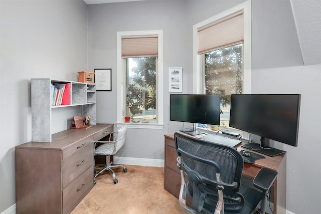 home office featuring light colored carpet and baseboards