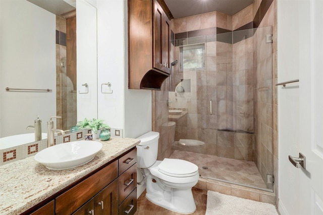 bathroom featuring a stall shower, vanity, and toilet