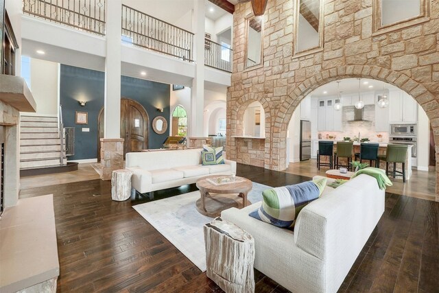 living room with dark hardwood / wood-style flooring and a high ceiling