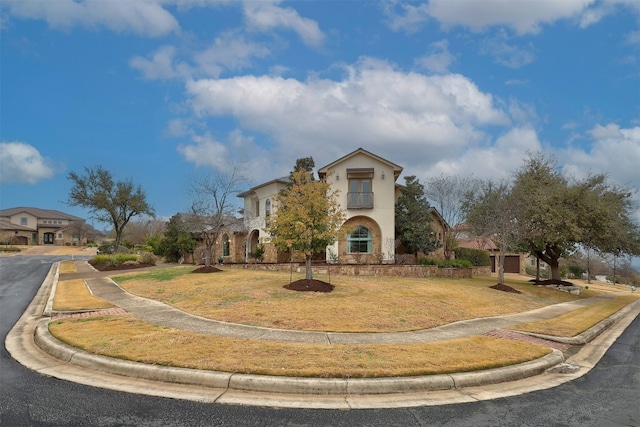 view of front of property with stucco siding and a front yard