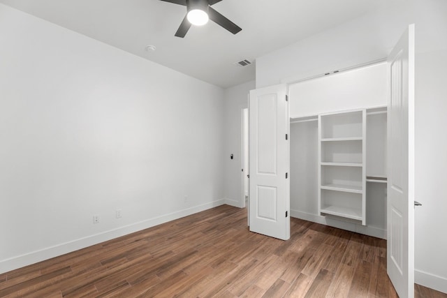 unfurnished bedroom with hardwood / wood-style flooring, a closet, and ceiling fan