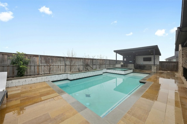 view of swimming pool with an in ground hot tub and a patio area