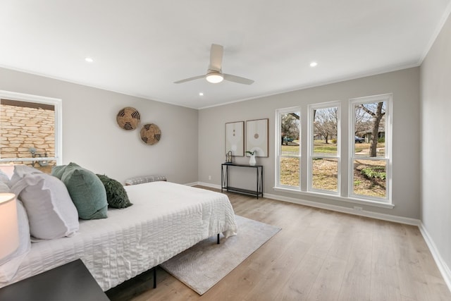 bedroom with light wood finished floors, recessed lighting, and baseboards