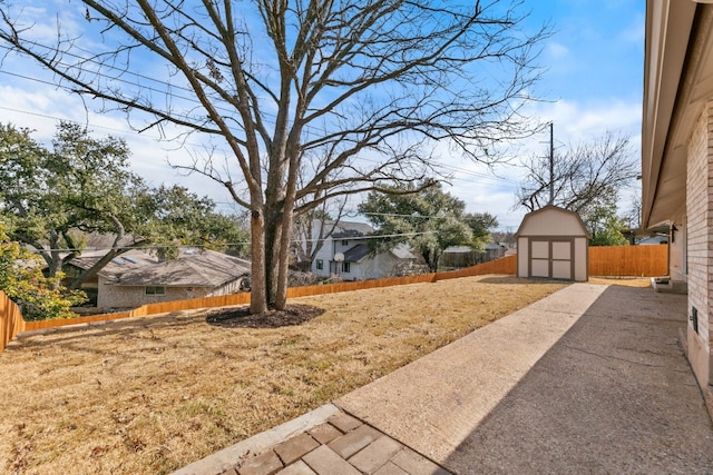 view of yard featuring a storage shed and a patio