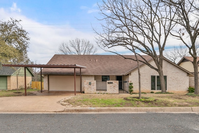 view of front facade featuring driveway, a fenced front yard, a garage, and brick siding