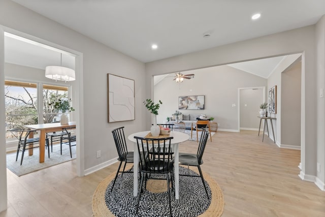 dining area with ceiling fan, lofted ceiling, and light hardwood / wood-style floors