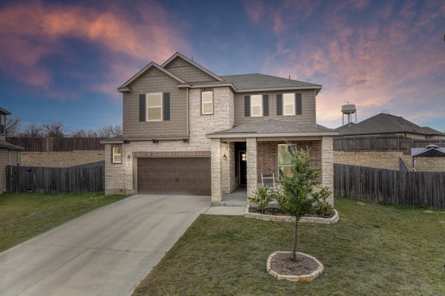 view of front of home with a garage and a yard