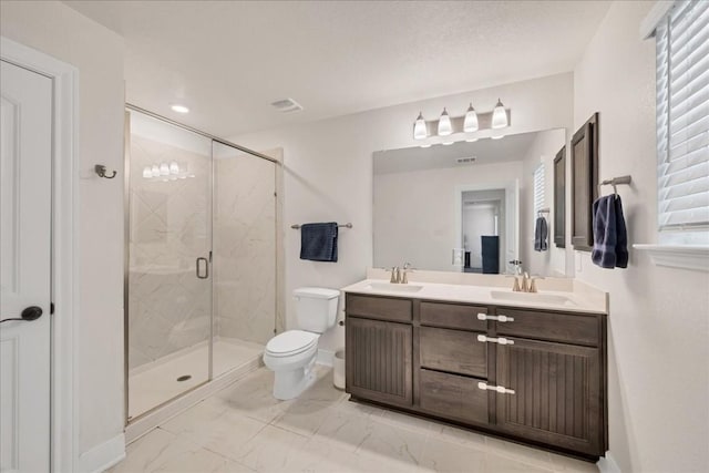 bathroom with a shower with door, vanity, and toilet