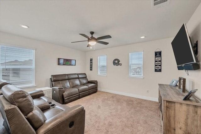 carpeted living room featuring ceiling fan