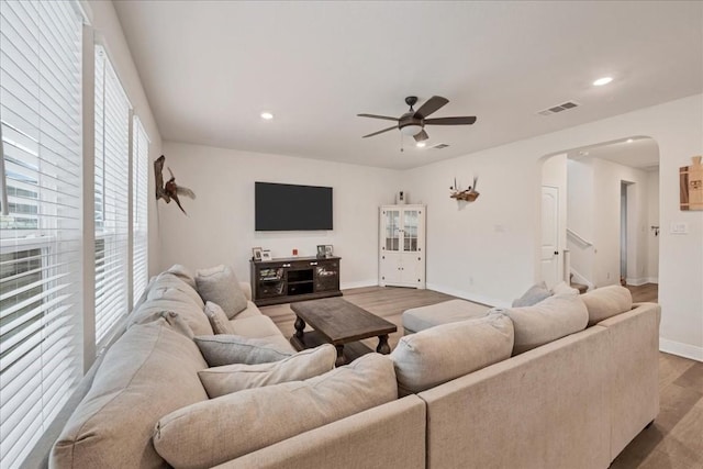 living room featuring ceiling fan and hardwood / wood-style floors