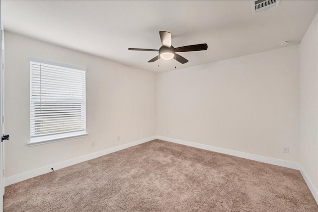 carpeted spare room featuring ceiling fan