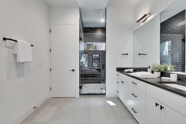 bathroom with vanity, an enclosed shower, and tile patterned flooring