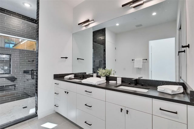 bathroom with tile patterned floors, vanity, and a shower with shower door