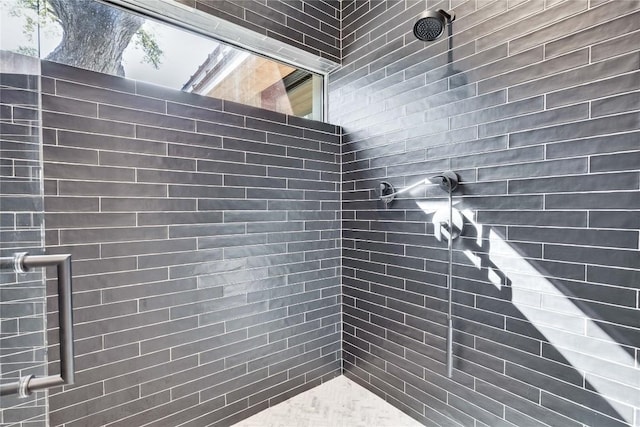 bathroom with tiled shower