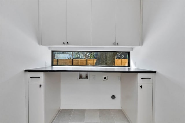 laundry area with cabinets, light tile patterned flooring, hookup for a washing machine, and hookup for an electric dryer