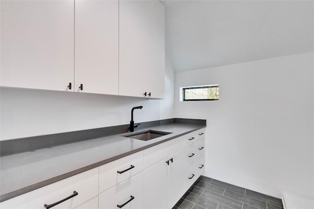 kitchen featuring sink and white cabinets