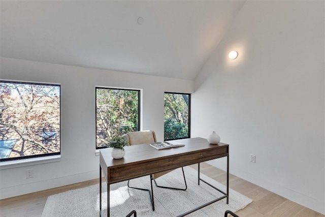 office space with lofted ceiling and light hardwood / wood-style flooring