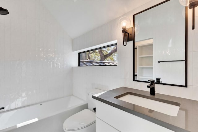 bathroom featuring vanity, toilet, vaulted ceiling, and tile walls