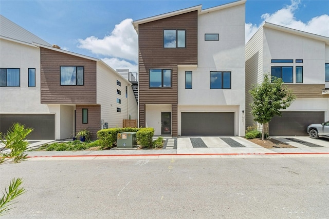 view of front of house featuring a garage and cooling unit