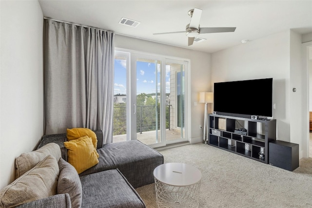 carpeted living room with ceiling fan