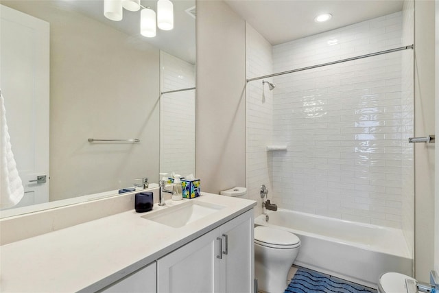 full bathroom with vanity, toilet, and tiled shower / bath combo