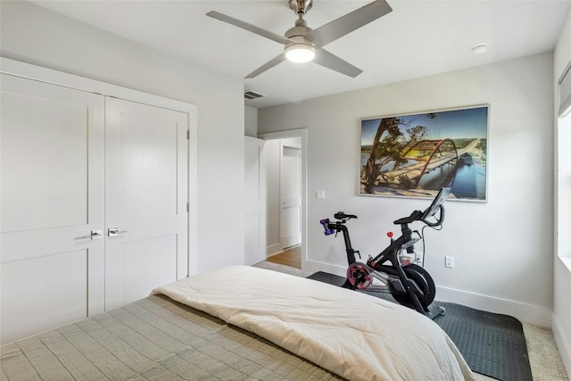 bedroom with ceiling fan and a closet