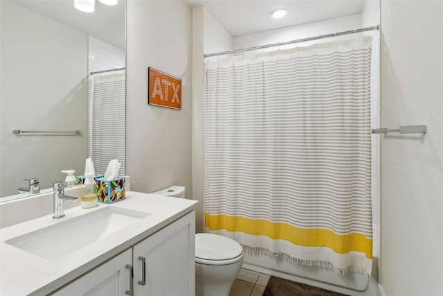 bathroom with vanity, tile patterned flooring, and toilet