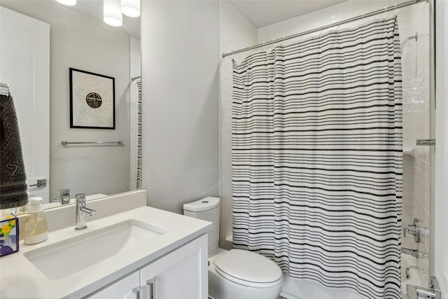 bathroom featuring vanity, toilet, and a tile shower