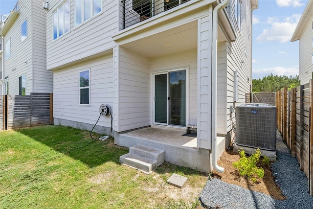 back of house with a yard and central AC unit