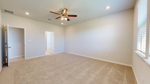 unfurnished bedroom with ceiling fan and light colored carpet