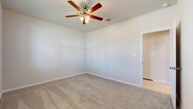 unfurnished room featuring light colored carpet and ceiling fan