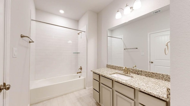 bathroom with vanity, tiled shower / bath combo, and hardwood / wood-style flooring