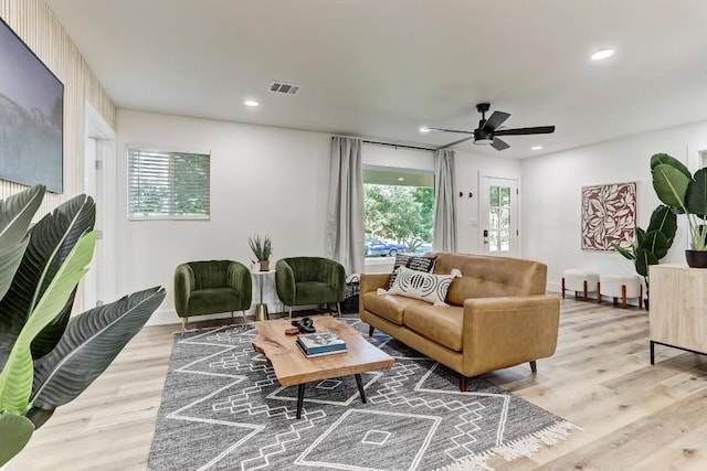 living room featuring ceiling fan and light wood-type flooring