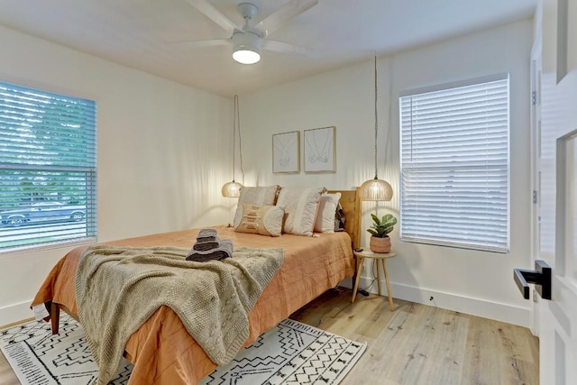 bedroom with light hardwood / wood-style flooring and ceiling fan