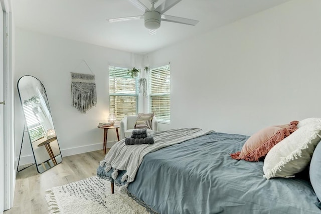 bedroom with light hardwood / wood-style floors and ceiling fan