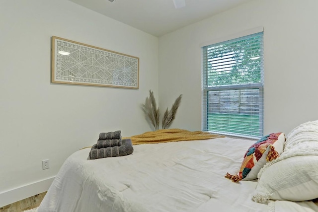 bedroom featuring hardwood / wood-style flooring and ceiling fan