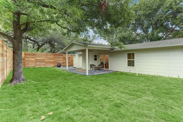 rear view of property with a yard and a patio area