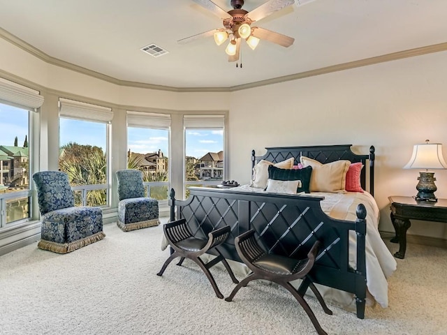 bedroom featuring ceiling fan, ornamental molding, and carpet flooring