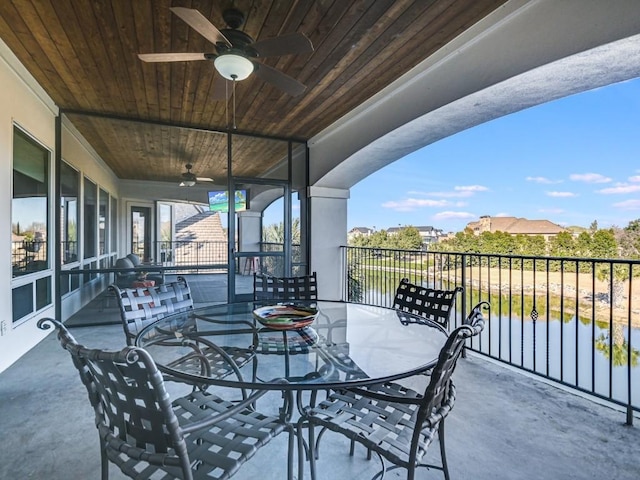 view of patio / terrace with a water view and ceiling fan