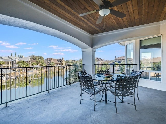 view of patio / terrace with ceiling fan and a water view