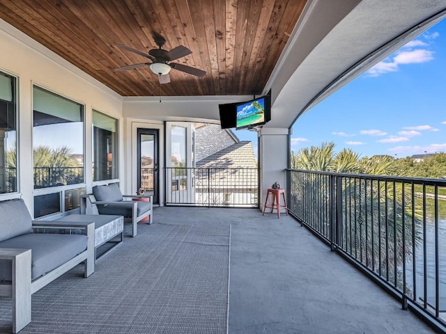 balcony with outdoor lounge area and ceiling fan