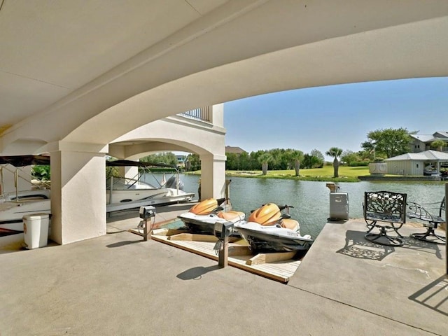 view of patio / terrace with a water view and a boat dock