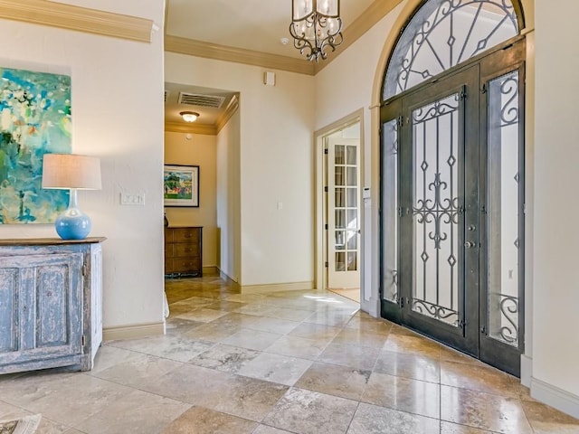 entryway with ornamental molding and a notable chandelier