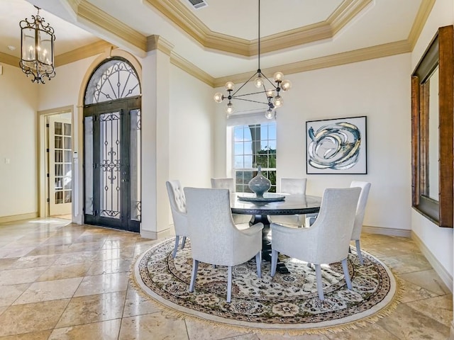 dining room with an inviting chandelier, crown molding, and a raised ceiling