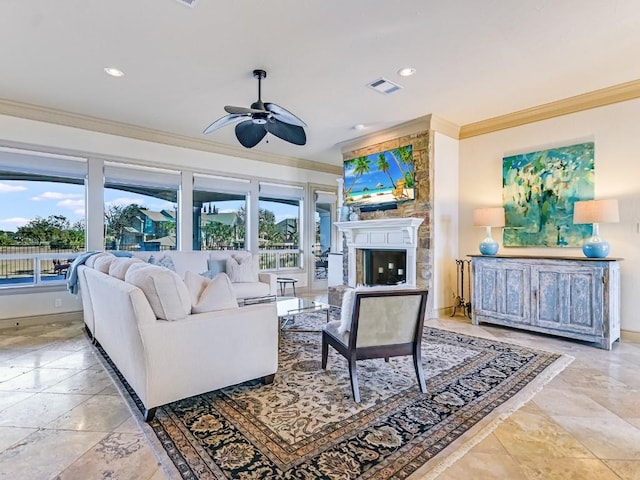 living room featuring crown molding, a large fireplace, and ceiling fan