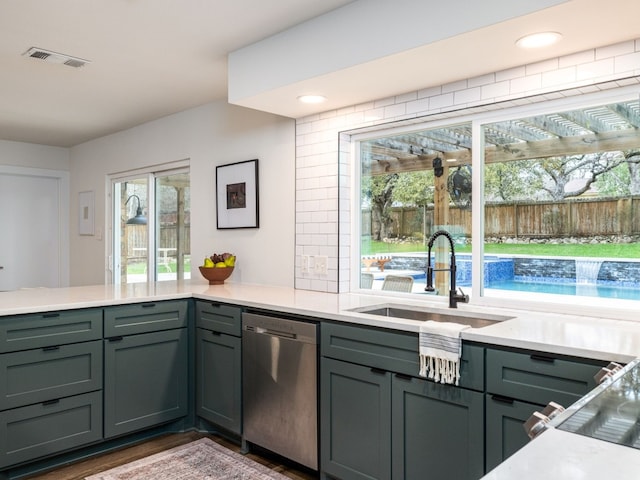 kitchen featuring dishwasher, sink, gray cabinetry, and dark hardwood / wood-style floors