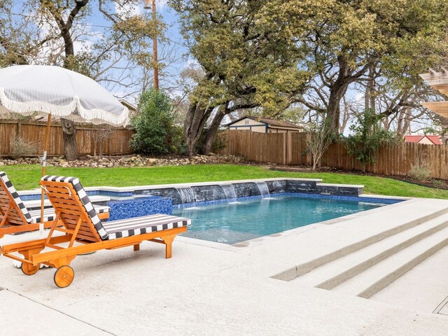 view of swimming pool with a patio, a yard, and pool water feature